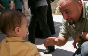 Jameel Dababneh, Caritas Jordan's emergency response coordinator, greets a Syrian boy in Mafraq (MCC Photo/J. Daryl Byler - April 2012)