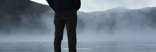 Man standing on the edge of a lake