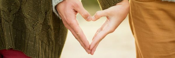 couple holding hands in shape of a heart